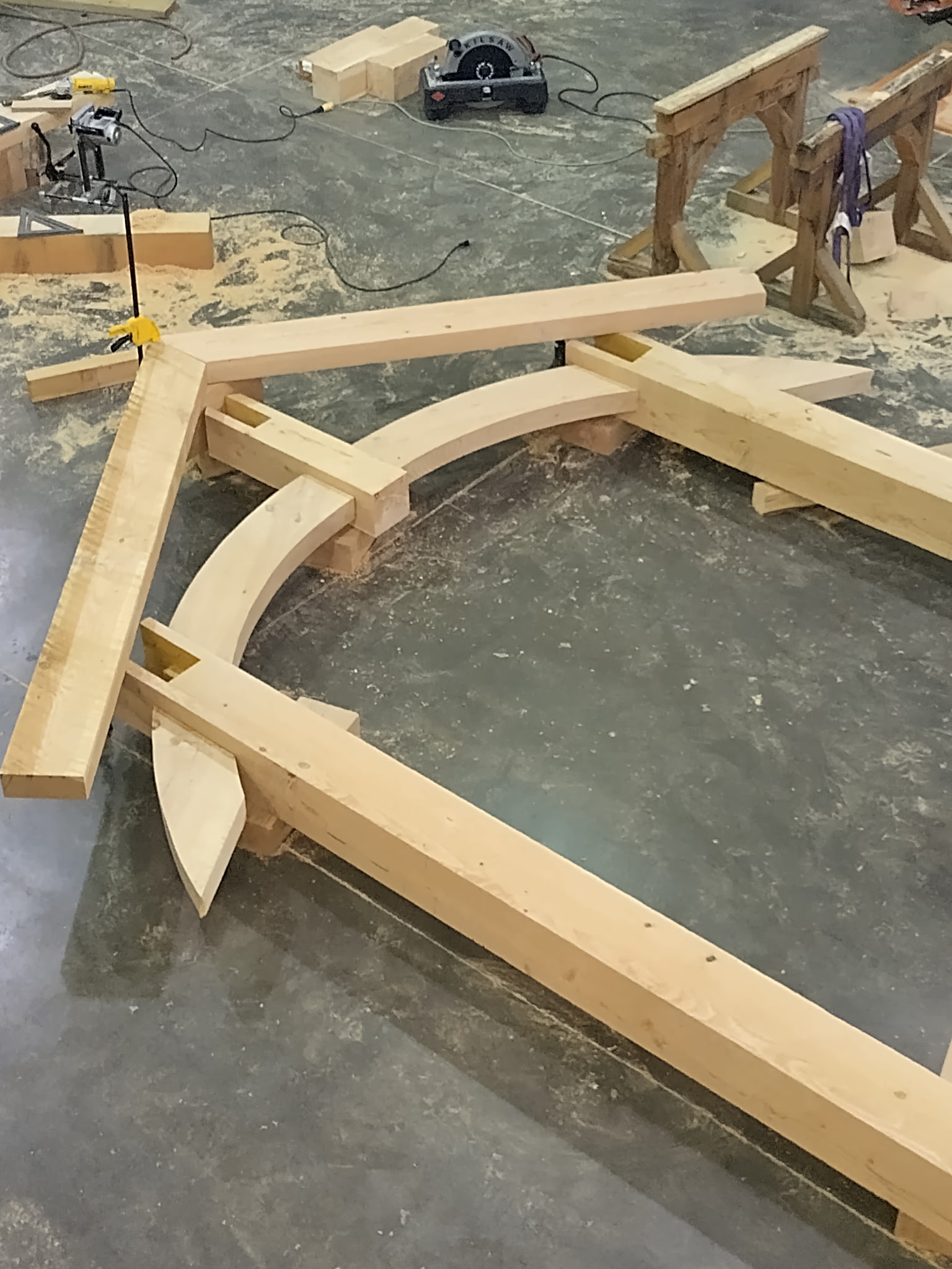 Curved custom timber truss laid out in the fabrication shop