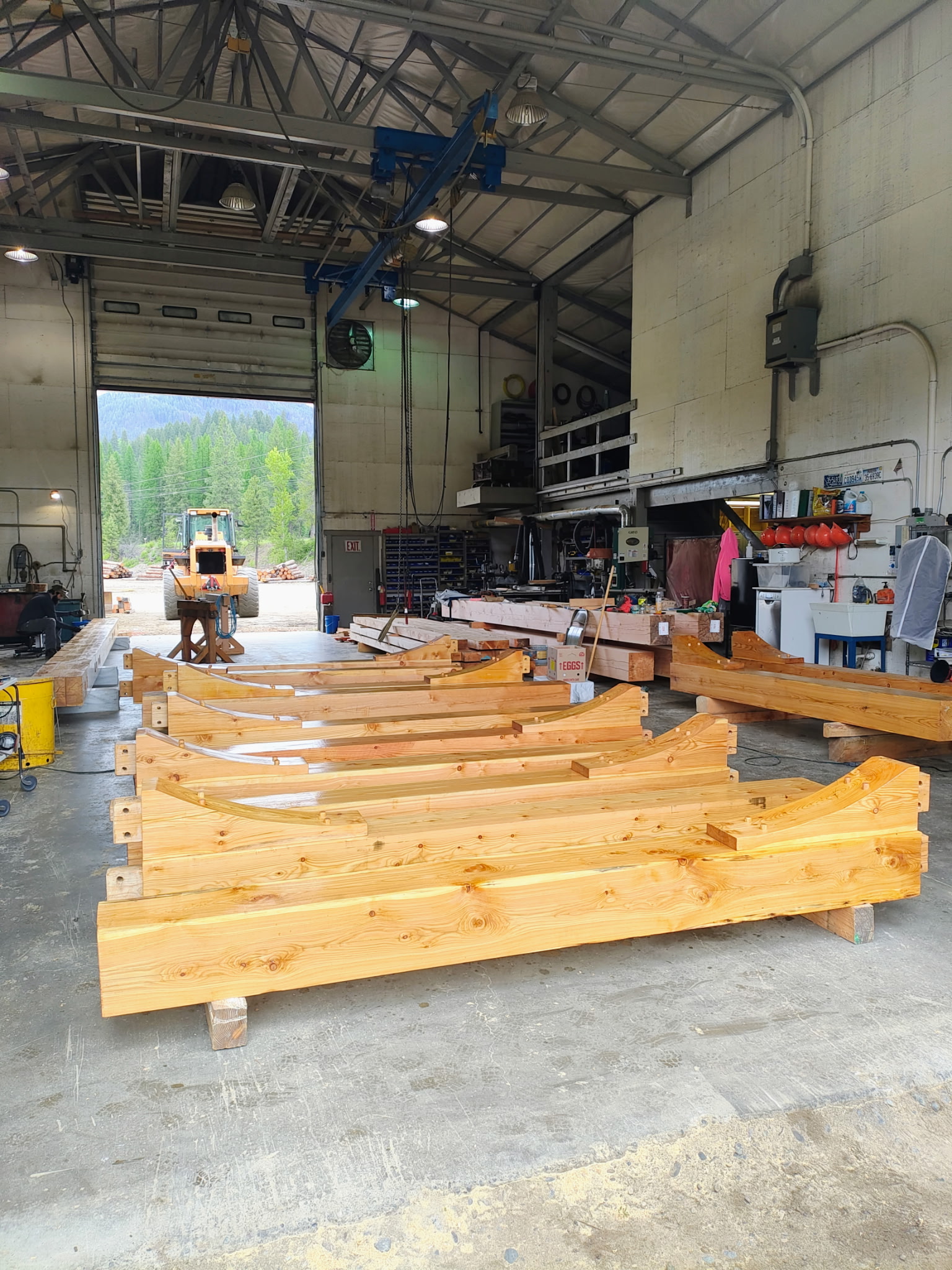 Completed timber-frame components arranged in the production facility