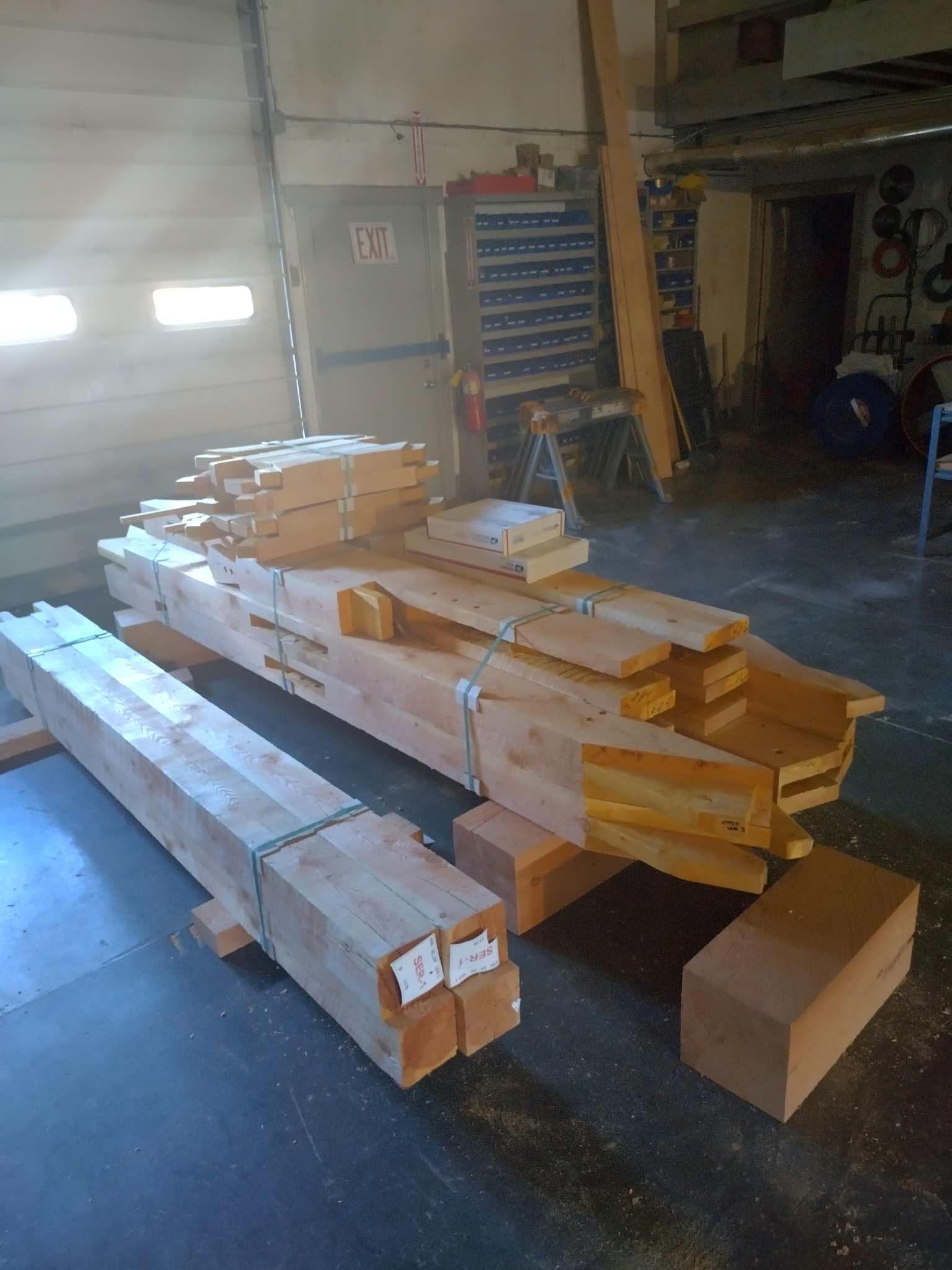 Stacks of precision-cut structural timber components in the Montana Beams workshop
