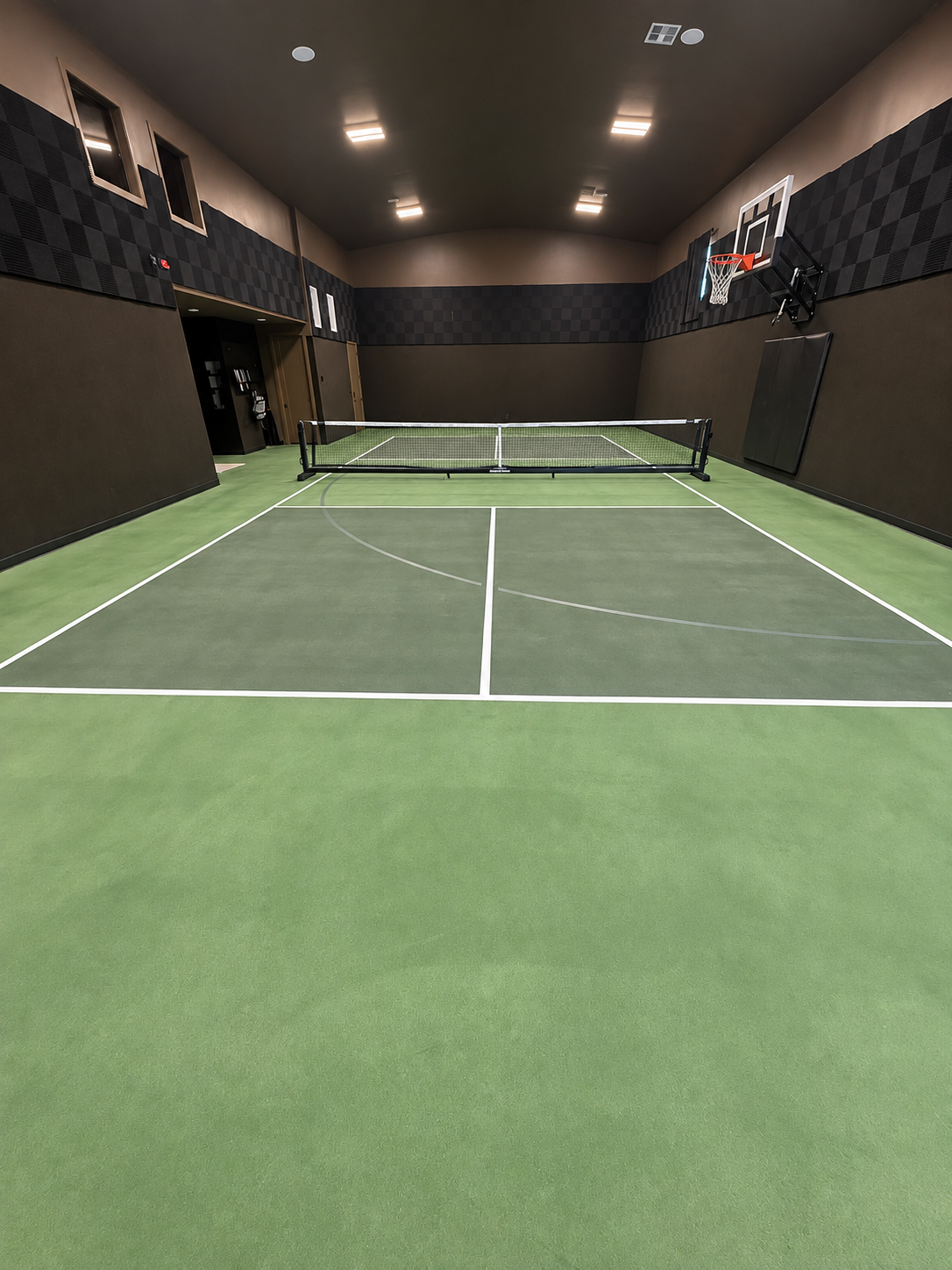 Green indoor pickleball and basketball court